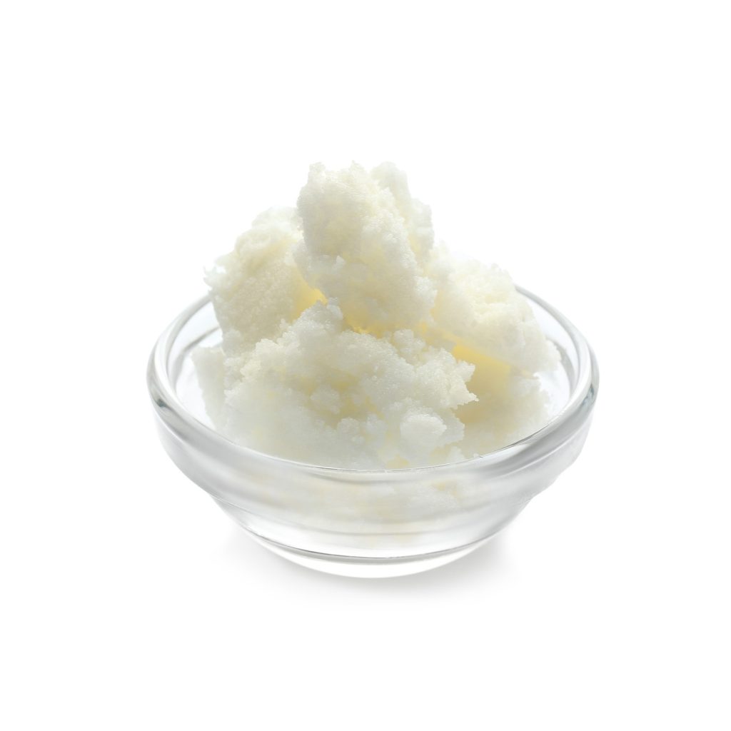 Cosmetic butter in glass dish on white background